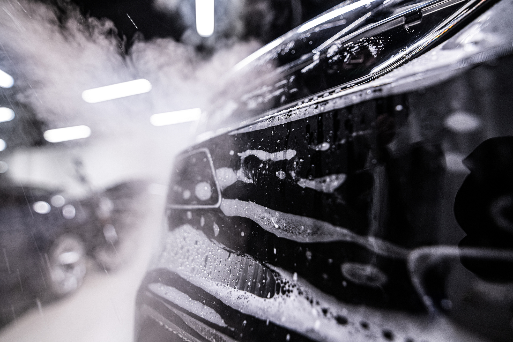 Auto detailer washing a vehicle
